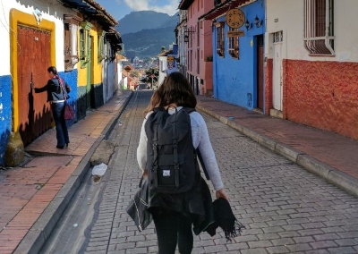 Girl going to school in Colombia through a colourfull street